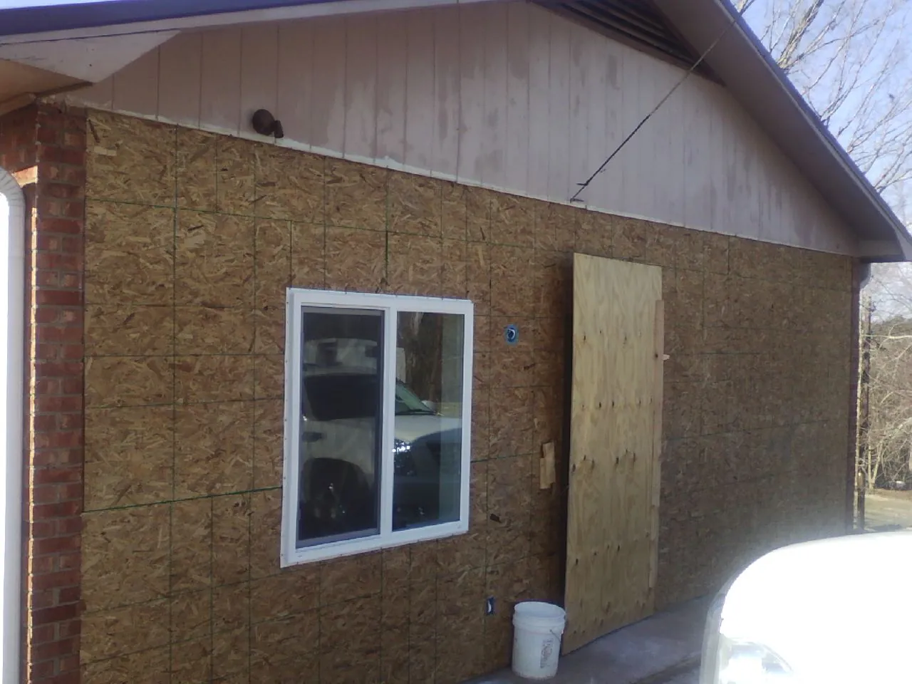 OSB sheathing on a garage addition wall before siding in Sheffield Lake