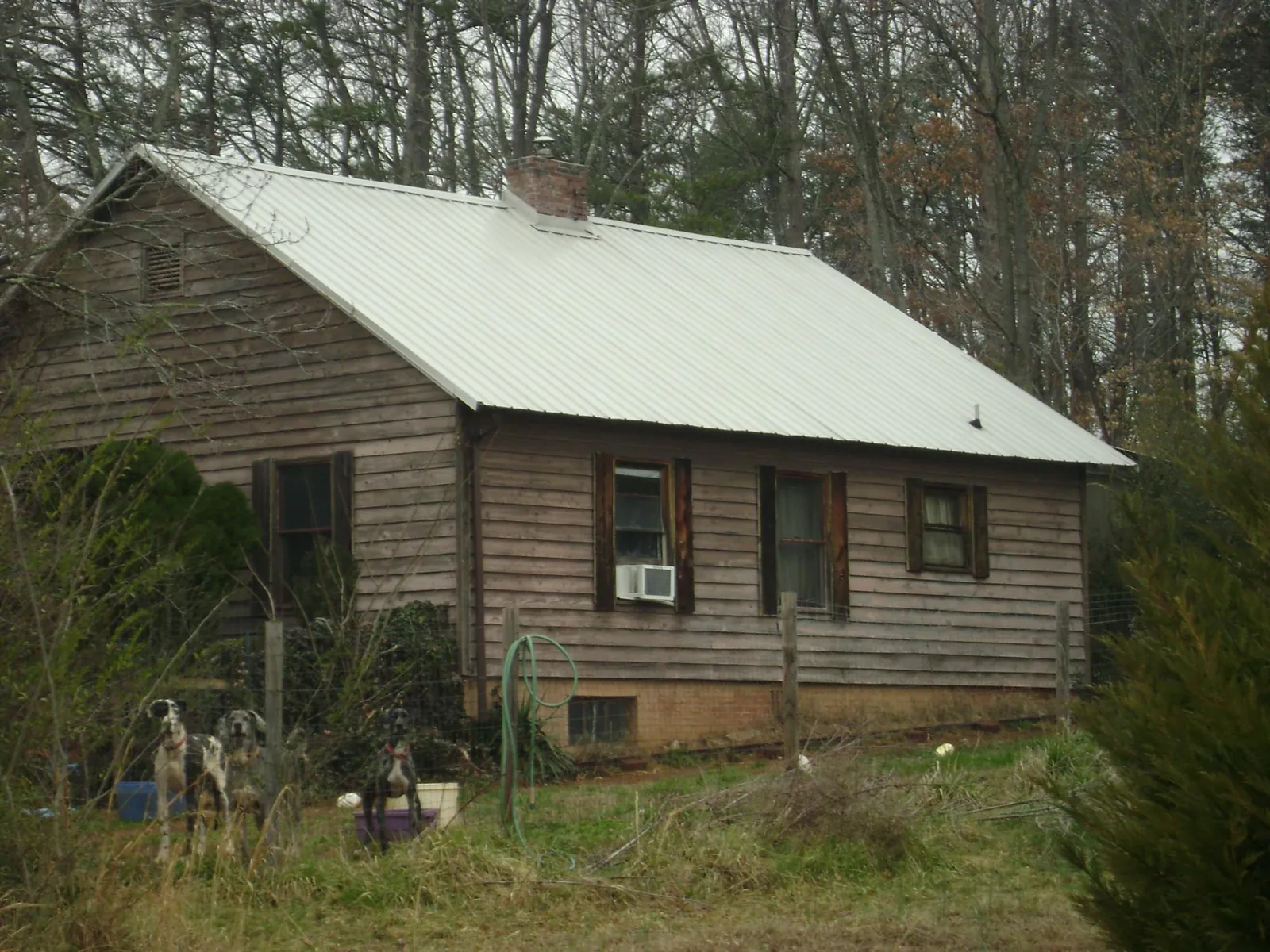 White metal roof on an old wood sided farmhouse, from a Metal Roof Installation job in Sheffield Lake